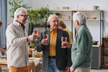 Group of senior men drinking red wine for conversation during a meeting