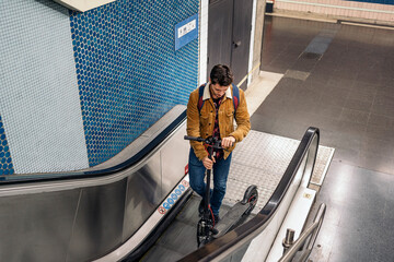 Guy Walking With Electric Scooter In Underground mechanic stairs