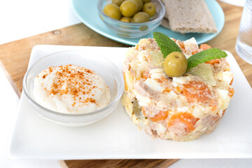 
Potato salad typical of Spanish cuisine. Typical Russian salad in Spanish cuisine. Plate of potato salad ready to eat. Food photos