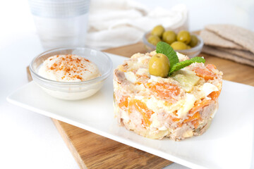 
Potato salad typical of Spanish cuisine. Typical Russian salad in Spanish cuisine. Plate of potato salad ready to eat. Food photos