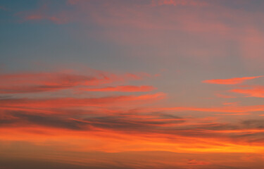 The sky at sunset at the sea beach in summer, The clouds are soft and fluffy floating on blue sky and pink and orange for backgrounds concept, Selective focus.