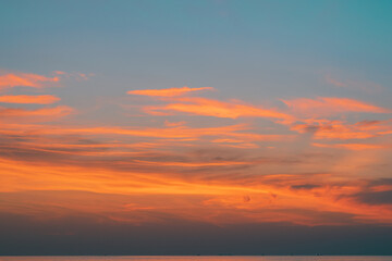 The sky at sunset at the sea beach in summer, The clouds are soft and fluffy floating on blue sky and pink and orange for backgrounds concept, Selective focus.