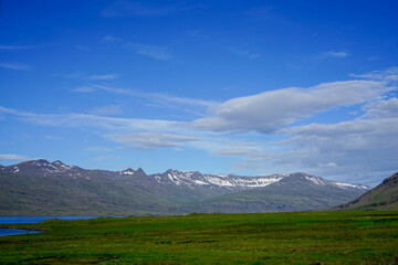 Image of a picnic under the wilderness with mountains, rivers and blue sky