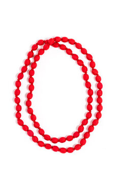 Vertical closeup of stylish upcycled red necklace made out of post-consumer waste, isolated on a white background. Creative reuse of waste, ideal gift for her.