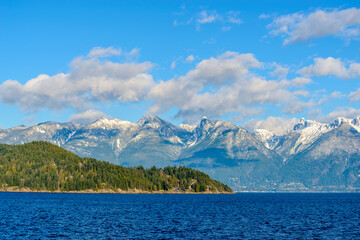 Fototapeta premium Fantastic view over ocean, snow mountain and rocks at Sechelt inlet in Vancouver, Canada.