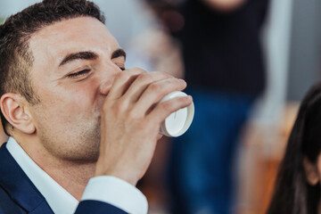 Portrait of Caucasian businessman drinking water.