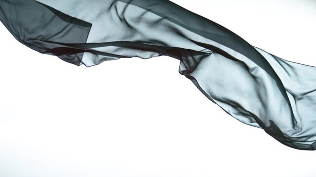 White transparent silk fabric flowing by wind, super slow motion