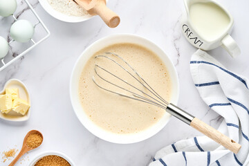 Preparation of dough for home pancakes for Breakfast or for Maslenitsa. Ingredients on the table - wheat flour, eggs, butter, sugar, salt, milk. Recipe step by step. Top view with place for text.