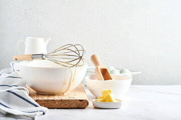 Preparation of dough for home pancakes for Breakfast or for Maslenitsa. Ingredients on the table - wheat flour, eggs, butter, sugar, salt, milk. Recipe step by step. Selective focus.