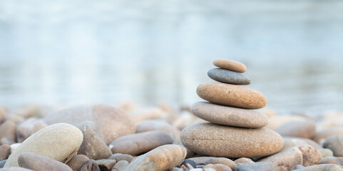 Fototapeta na wymiar Balance stones close up on a stone beach at sunrise