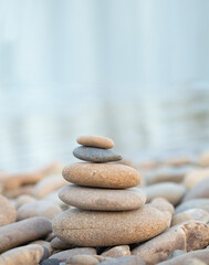 Fototapeta na wymiar Balance stones close up on a stone beach at sunrise