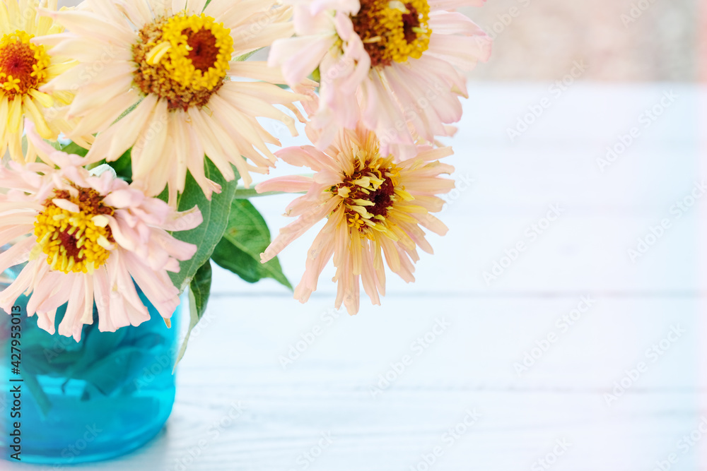 Poster light and airy zinnia flower bouquet on wood background with copy space for mother's day during spri