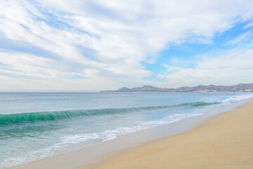 Set of pictures of a fantastic ocean wave in different stages. Cloudy sunrise sky. San Jose del Cabo. Mexico.