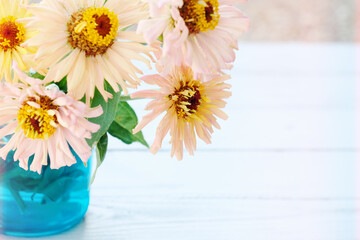 Light and airy zinnia flower bouquet on wood background with copy space for mother's day during spring.