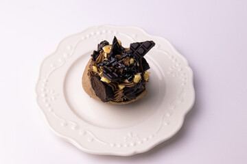 Close up Chocolate Mousse Cake topped with Crunchy Nuts