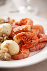 Grilled prawns and cuttlefish on a plate. High quality photo.