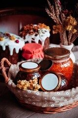 Jars of jam in a beautiful wicker basket. Festive Easter basket. Place for your text.