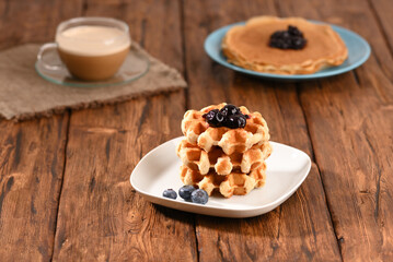 Appetizing waffles with jam for dessert.