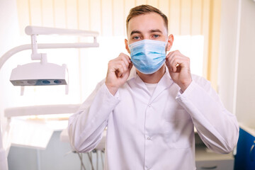 Fototapeta na wymiar Dentist wearing a mask during a dental operation. He was standin