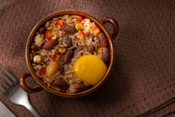 rice and beans with egg on dark wooden table