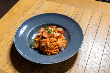 Smoked salmon risotto served on a restaurant table