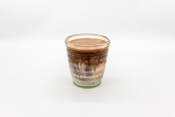Dirty chocolate on top of cold milk isolated on white