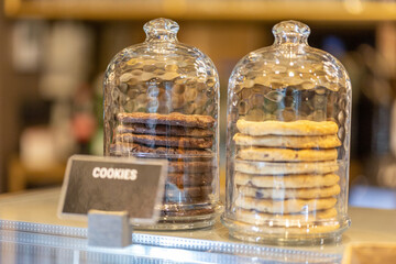 Cookies under glass bell in cafe bar