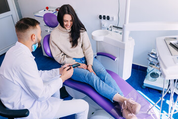 beautiful patient sitting in a professional chair and doctor sho © Ivan