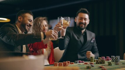 Two bearded men and young woman are winning and rejoice in victory at the casino. Entertainment industry and luxury lifestyle. Concept of casino gambling and poker.