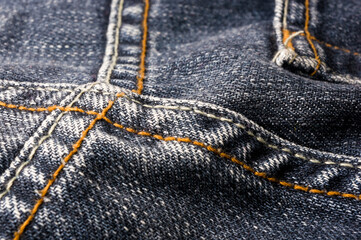 clothing items blue stonewashed faded jeans cotton fabric texture with seams, clasps, buttons and rivets, macro, close-up