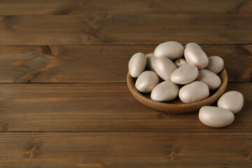 Raw jackfruit seeds on wooden table. Space for text