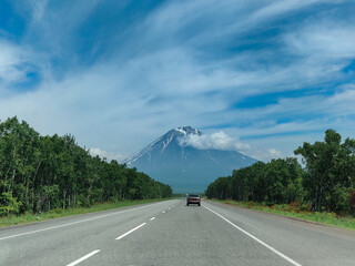 A mountain on the horizon. Car trip to the mountains.