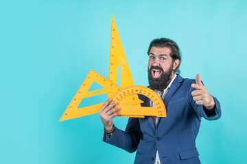 brutal unshaven guy university lecturer with math ruler, school