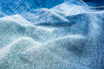 clothing items blue stonewashed faded jeans cotton fabric texture with seams, clasps, buttons and rivets, macro, close-up