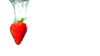 Strawberry falling in water. Splashing water