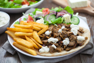 Greek Gyros with Fries and Salad on a Plate.