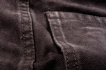 clothing items stonewashed cotton fabric texture with seams, clasps, buttons and rivets, macro
