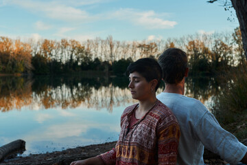 close up of a couple meditating in a lake