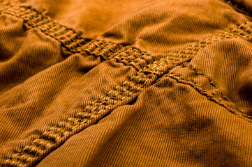 clothing items stonewashed cotton fabric texture with seams, clasps, buttons and rivets, macro