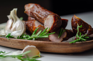 Traditional Polish juniper sausage on a wooden plate, luxury smoked product