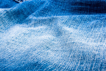 clothing items blue stonewashed faded jeans cotton fabric texture with seams, clasps, buttons and...