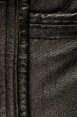Old vintage genuine soft black leather texture background, top layer with pores and scratches,...