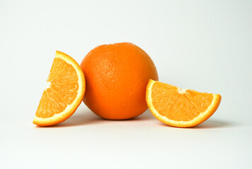 Citrus fruit and orange slice on white background.