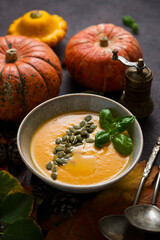 Autumn pumpkin spice soup with pumpkin seeds and olive oil