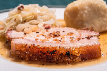 Slice of Austrian Roast Pork called Schweinsbraten with Coleslaw and Potato Dumpling