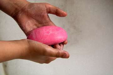 They wash their hands in the sink with soap.