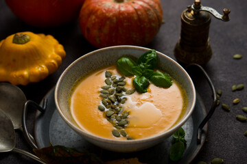 Hot autumn pumpkin soup with pumpkin seeds, copy space
