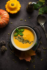 Hot autumn pumpkin soup with pumpkin seeds