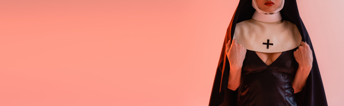 cropped view of young nun in sexy dress on pink background, banner