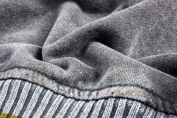 clothing items stonewashed cotton fabric texture with seams, clasps, buttons and rivets, macro